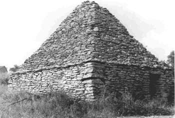 Bonnieux (Vaucluse) : cabane en forme de parallélépipède surmonté d'une pyramide aux faces planes avec collerette © Christian Lassure